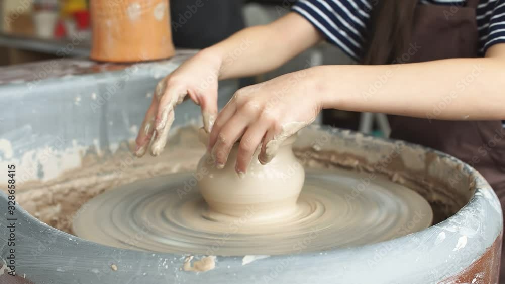 Kid is Working at Pottery Wheel Slowly and Molding a Vase, Blonde Little Girl People Are Making a Gifts From a Clay, Learning a Pottery Craft.