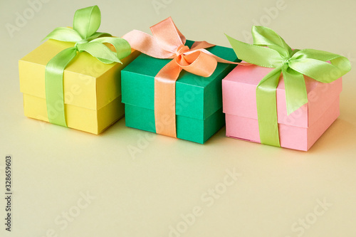 Multicolored gift boxes with ribbon on a light background