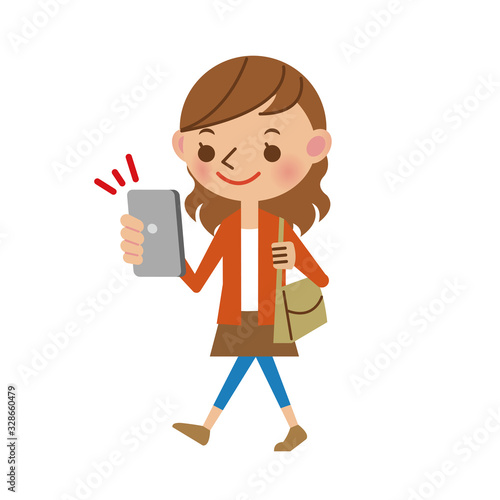 スマートフォンを操作しながら歩く若い女性