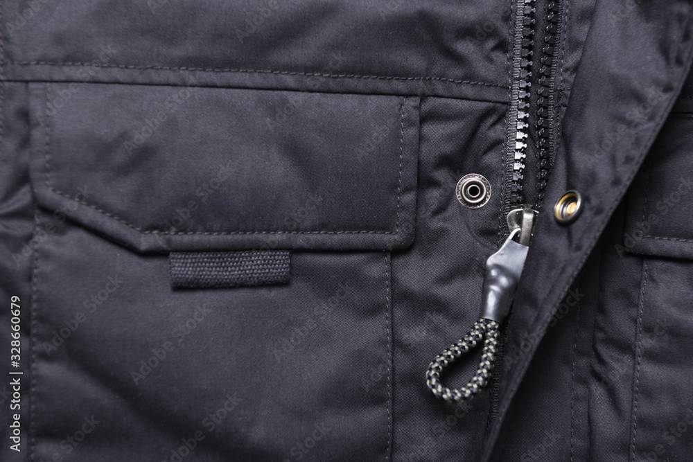 Closeup of black zipper on a wintry black jacket.Zipper winter jacket, close-up. Closeup of black zipper on a wintry black jacket.Zipper winter jacket, close-up.