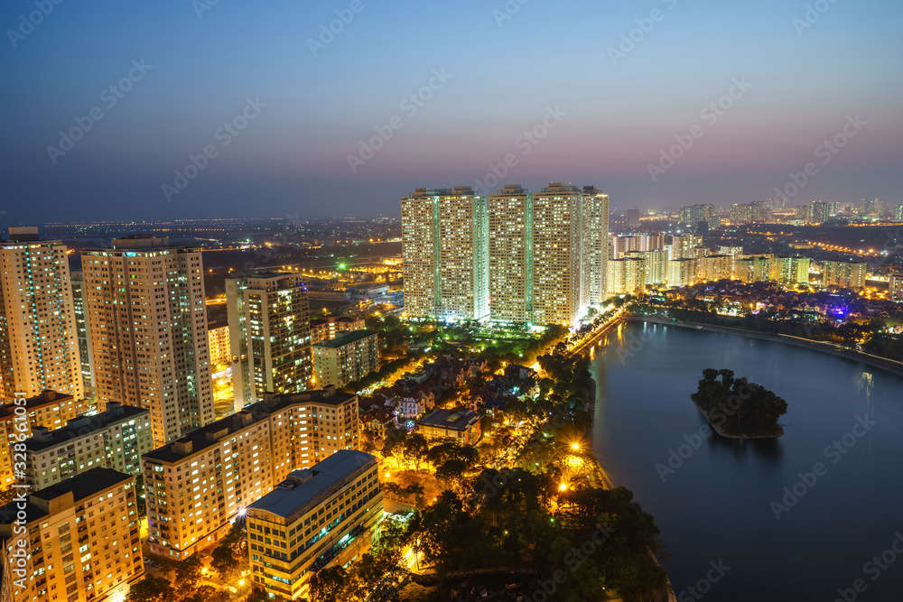 Obraz premium Aerial skyline view of Hanoi city, Vietnam. Hanoi cityscape by sunset period at Linh Dam lake, Hoang Mai district