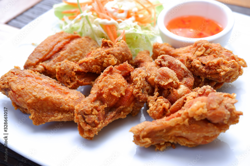 Chicken fired unhealthy food with spicy sauce on white plate