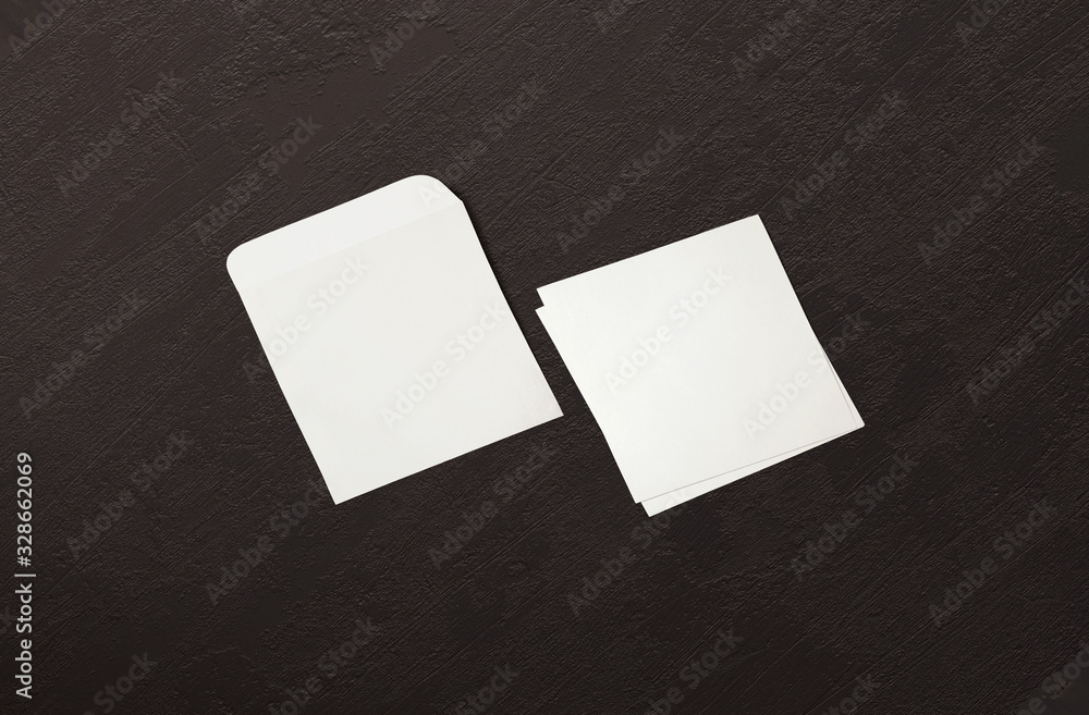 White envelope and post card on background. Top view blank envelope mockup and blank letterhead presentation template. Empty sheet for your design. White envelope and post card on background. Top view blank envelope mockup and blank letterhead presentation template. Empty sheet for your design.