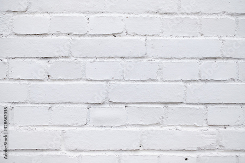 Wall of brick painted with white paint.