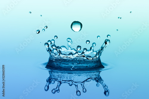 Water splash in crown shape with falling drop