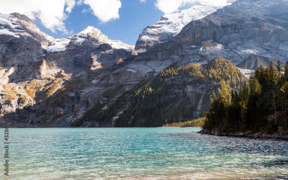Oeschinensee lake in Kandersteg, Switzerland. Nature background with mountain and water