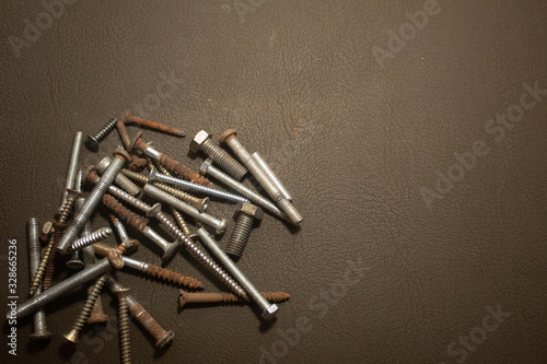 rusty nails and screw on leather background