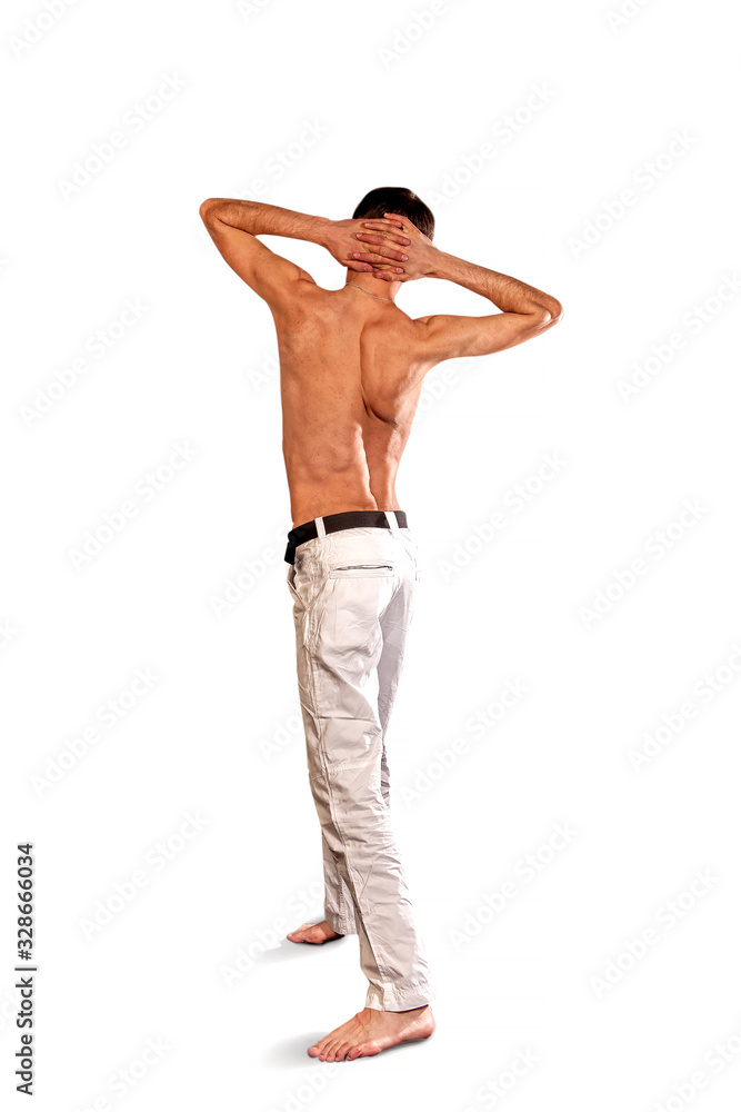 Fototapeta premium young guy stands with his back in white pants
