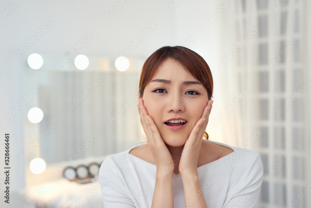 Portrait of beautiful woman with natural make up touching her face. Beauty young woman with fresh clean perfect skin.