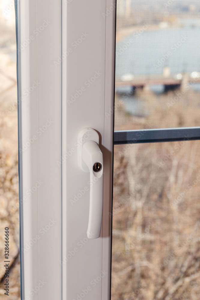 Handle with a lock on the window frame, a safety tool for children Handle with a lock on the window frame, a safety tool for children