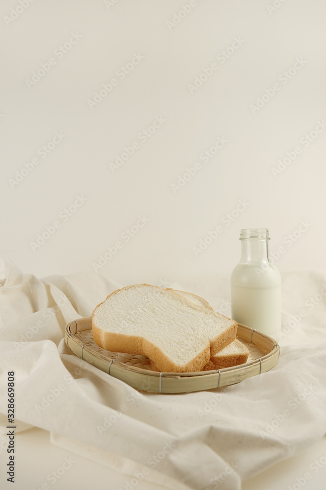 Breakfast set fresh milk and bread on canvas background Breakfast set fresh milk and bread on canvas background