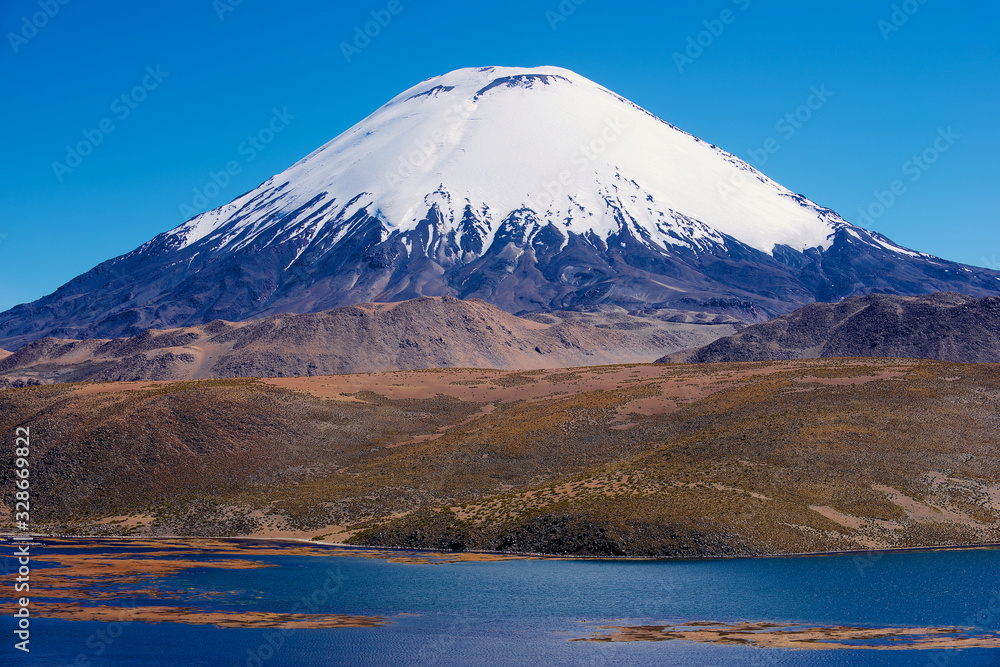 Chungara lake and snow capped Parinacota volcano with clear blue sky in Lauca National park, Chile. Chungara lake and snow capped Parinacota volcano with clear blue sky in Lauca National park, Chile.
