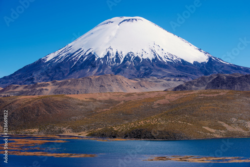 Chungara lake and snow capped Parinacota volcano with clear blue sky in Lauca National park  Chile.