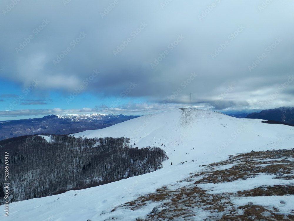 Winter mountain landscape with clouds