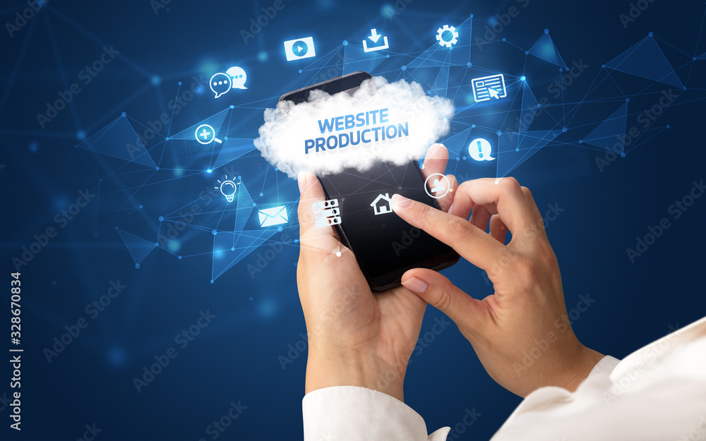 Female hand holding smartphone with WEBSITE PRODUCTION inscription, cloud technology concept Female hand holding smartphone with WEBSITE PRODUCTION inscription, cloud technology concept