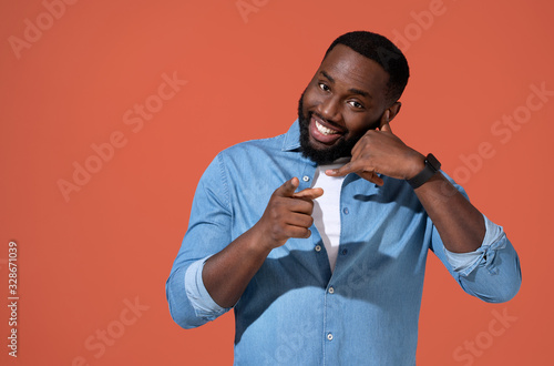Cuadro en lienzo Man makes phone gesture of calling and pointing to you, call me back sign