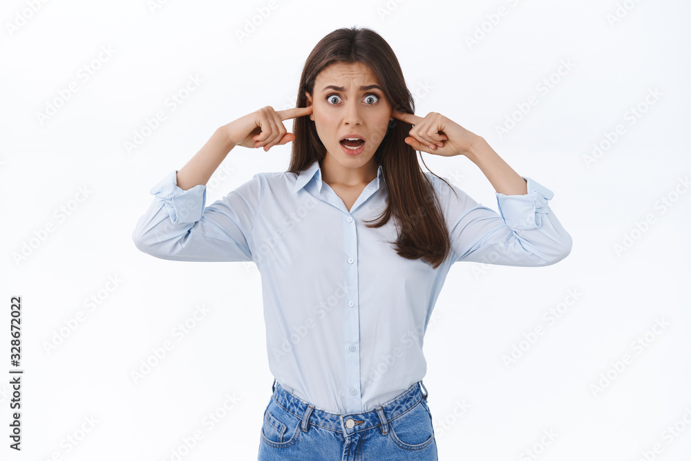 Woman going insane from loud awful music playing neigbours, complaining on noise grimacing bothered and displeased, feel huge discomfort plug fingers in ears, white background Woman going insane from loud awful music playing neigbours, complaining on noise grimacing bothered and displeased, feel huge discomfort plug fingers in ears, white background