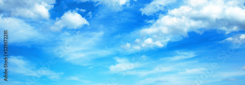 Sunny background, blue sky with white cumulus clouds 