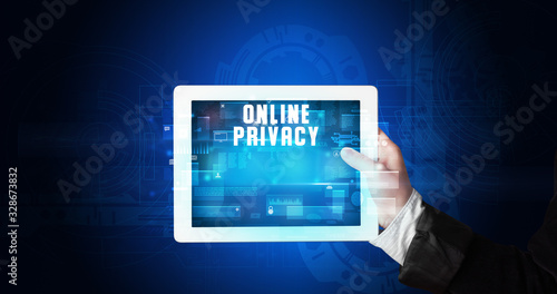 Wallpaper Mural Young business person working on tablet and shows the digital sign: ONLINE PRIVACY Torontodigital.ca