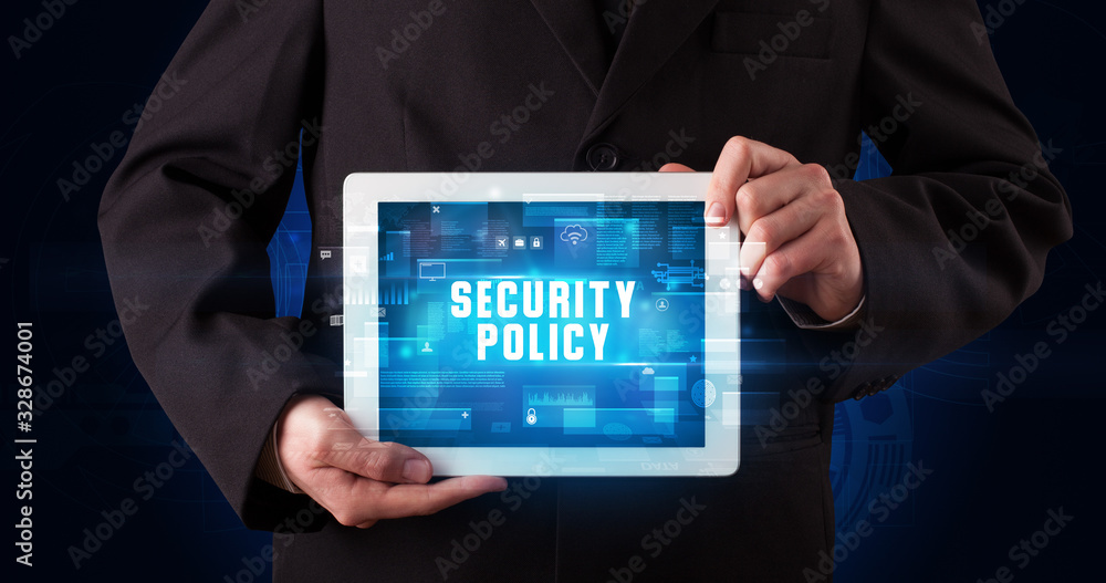 Young business person working on tablet and shows the digital sign: SECURITY POLICY Young business person working on tablet and shows the digital sign: SECURITY POLICY