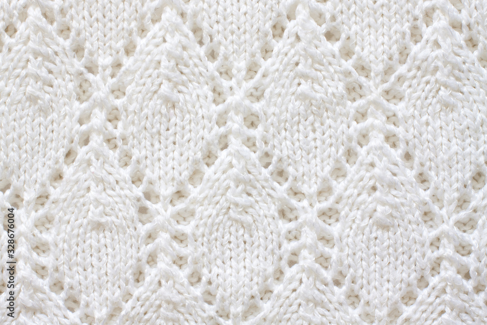 Knitting pattern, white rhombus design, lace fabric, handmade openwork knitted stitch mock up