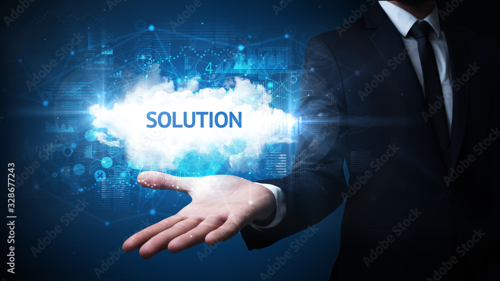 Hand of Businessman holding SOLUTION inscription, successful business concept Hand of Businessman holding SOLUTION inscription, successful business concept