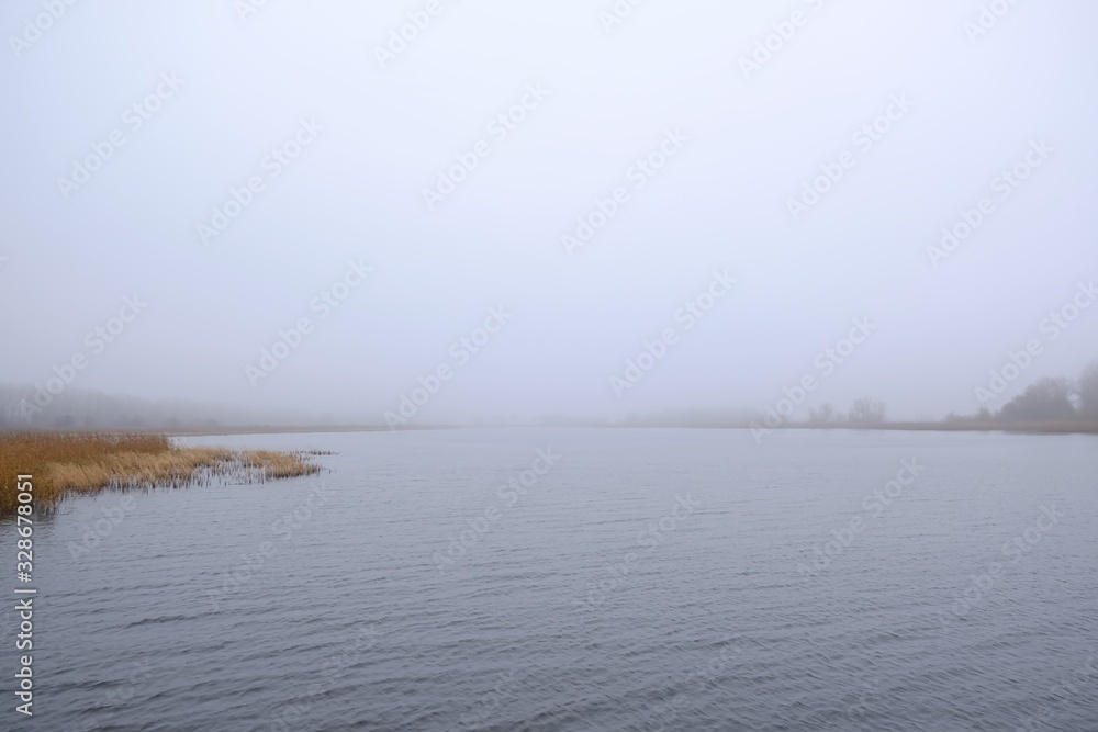 A moody landscape, an empty misty lake - peace and quiet. Kamien Pomorski, Poland A moody landscape, an empty misty lake - peace and quiet. Kamien Pomorski, Poland