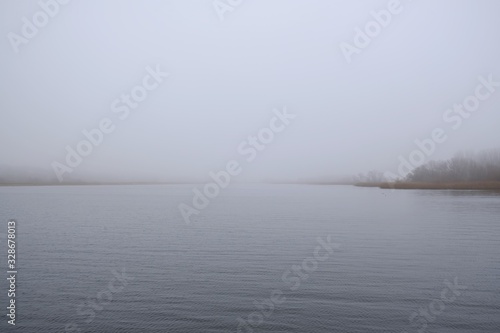 A moody landscape, an empty misty lake - peace and quiet. Kamien Pomorski, Poland