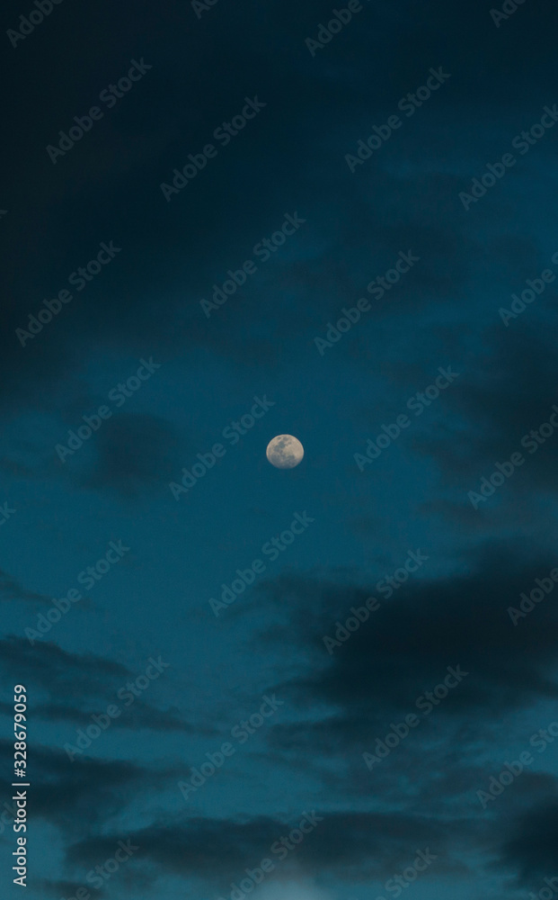 Moon unsigned on a cloudy sky