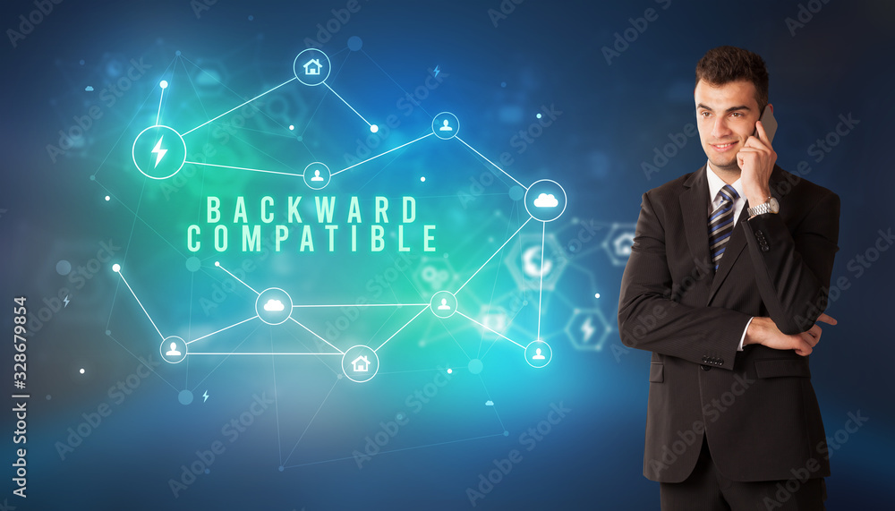 Businessman in front of cloud service icons with BACKWARD COMPATIBLE inscription, modern technology concept Businessman in front of cloud service icons with BACKWARD COMPATIBLE inscription, modern technology concept