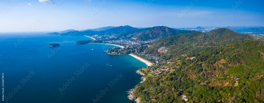 Aerial panorama of the green coastline with tropical beaches on the island of Phuket, Thailand. Beaches are: Kata Noi (closest), Kata, Karon.