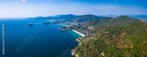 Aerial panorama of the green coastline with tropical beaches on the island of Phuket, Thailand. Beaches are: Kata Noi (closest), Kata, Karon.