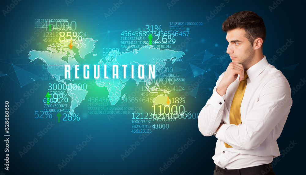 Businessman in front of a decision with REGULATION inscription, business concept Businessman in front of a decision with REGULATION inscription, business concept