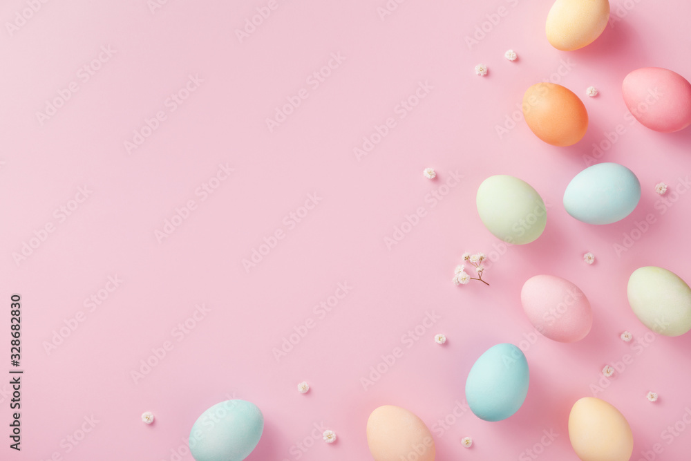 Foto Pastel Easter eggs on pink background top view. Flat lay style.