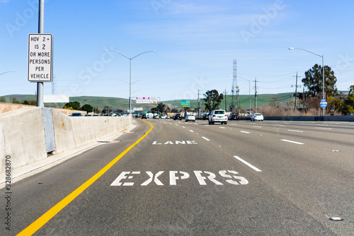 Express Lane marking on the freeway; San Francisco Bay Area, California; Express lanes help manage lane capacity by allowing single occupancy vehicles to use them for a fee