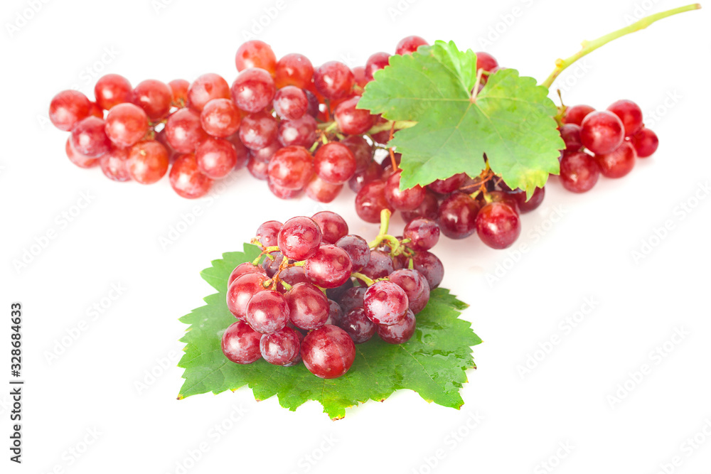 Ripe red grape with leaves isolated on white background Ripe red grape with leaves isolated on white background