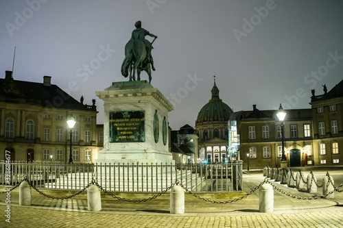 Night view to equestrian statue of King Frederik V on Amalienborg Palace Square. Copenhagen, Denmark. February 2020