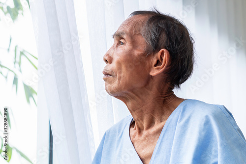 Senior man patient thinking and dream about life on hospital bed.