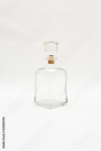 Vintage glass decanter made of transparent glass without a pattern on a white background