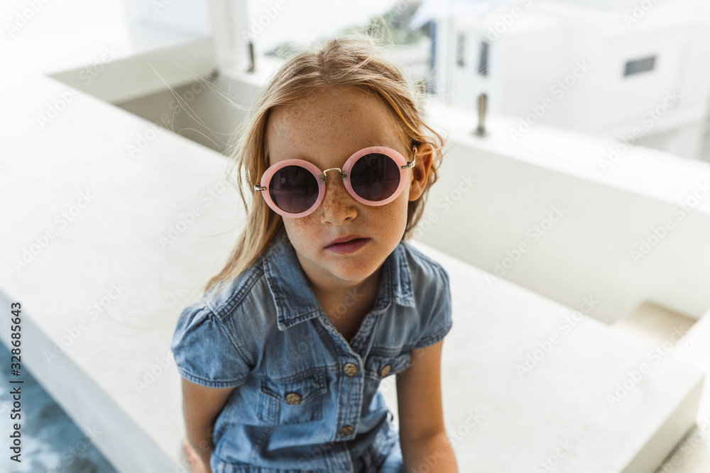 Little girl with red hair shows different emotions. Sadness, joy and happiness. She smiles and cries. In jeans with skin pigment on his face, freckles overlooking the sea. FASHIONABLE CHILD Little girl with red hair shows different emotions. Sadness, joy and happiness. She smiles and cries. In jeans with skin pigment on his face, freckles overlooking the sea. FASHIONABLE CHILD