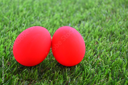 red easter egg on lawn green grass artificial, image of morning springtime concept