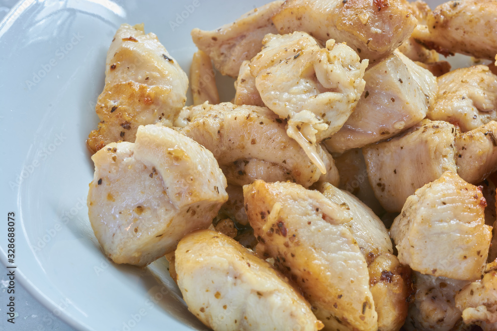 Fried chicken meat in spices on a plate Fried chicken meat in spices on a plate