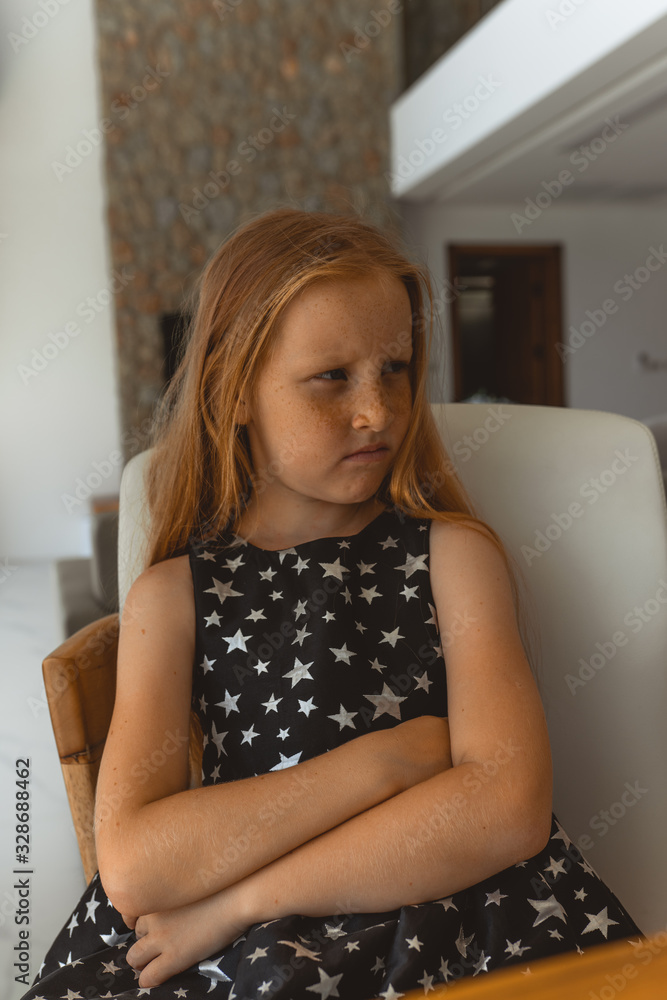 Little girl with red hair shows different emotions. Sadness, joy and happiness. She smiles and cries. In a black dress with skin pigment on her face, freckles Little girl with red hair shows different emotions. Sadness, joy and happiness. She smiles and cries. In a black dress with skin pigment on her face, freckles