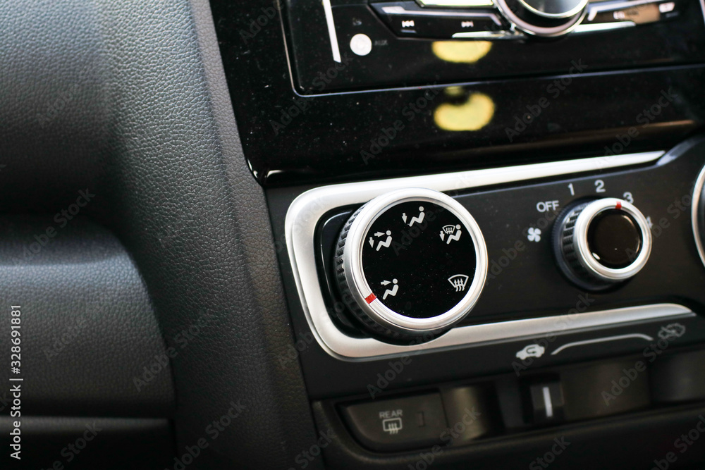 Detail with the air conditioning button inside a car.Control panel car air conditioner dashboard / console Technology in a modern car.Modern interior details. Detail with the air conditioning button inside a car.Control panel car air conditioner dashboard / console Technology in a modern car.Modern interior details.