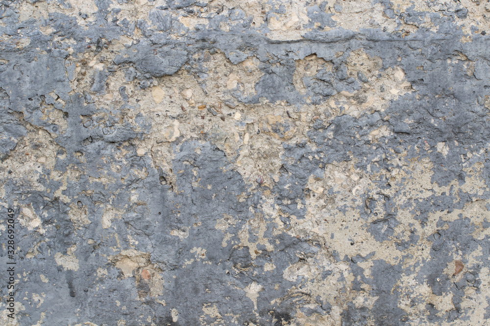 Background from old crumbling concrete covered in black paint. Stones stick out of old cement. Close-up. High quality Background from old crumbling concrete covered in black paint. Stones stick out of old cement. Close-up. High quality
