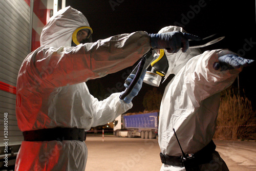 Ecology specialists in chemical clothing and masks who work in areas affected by the coronavirus