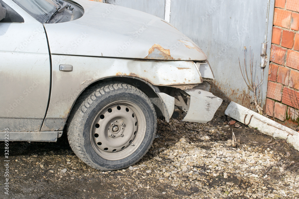 Broken, dirty Russian car on the street. Right wing and wheel. Broken, dirty Russian car on the street. Right wing and wheel.