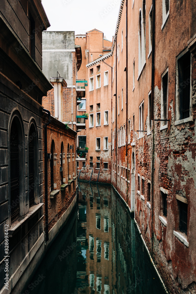 View of the rustic architecture of Venice, Italy canal alley 