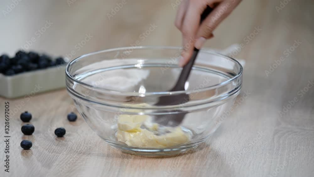 Mixing soft butter and sugar in bowl. Mixing soft butter and sugar in bowl.