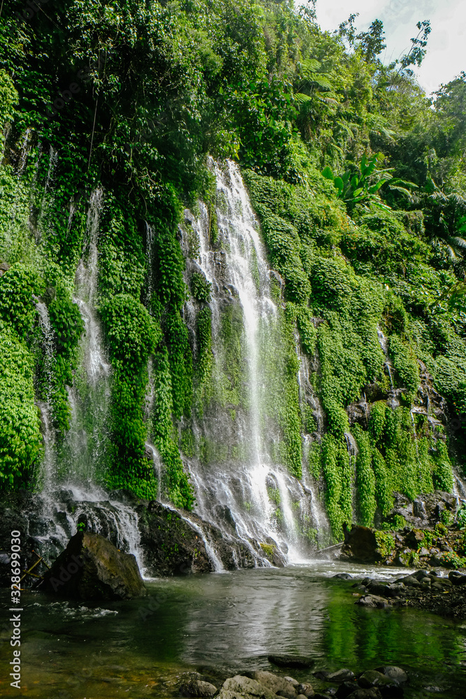 Beautiful and scenic view of Asik-asik Falls in Alamada, Cotabato, Philippines. Water from this waterfalls comes directly from the wall of a towering mountain.